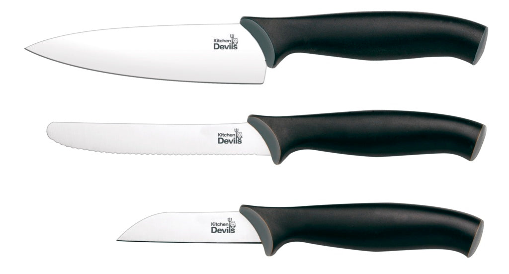 Kitchen Devils Control Starter Set knives laid out showing paring knife, multi-purpose knife and small cook's knife with black ergonomic handles