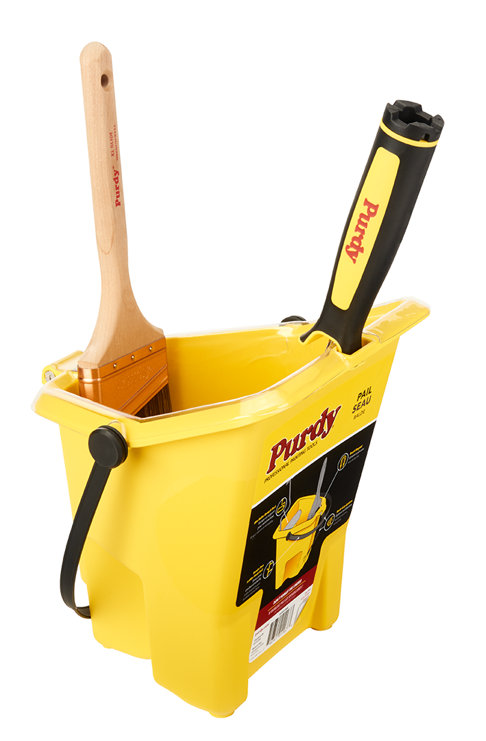 Purdy Pail with a paintbrush resting on the integrated magnet and a mini roller on the ramp
