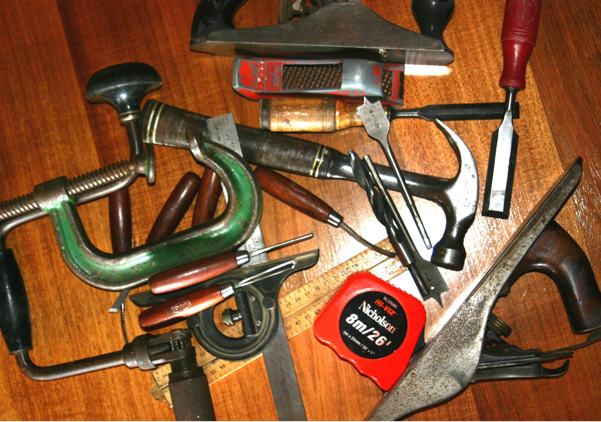 Woodworking tools laid out on a wooden workbench