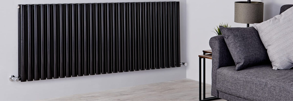 Matt black vertical radiator in a modern living room