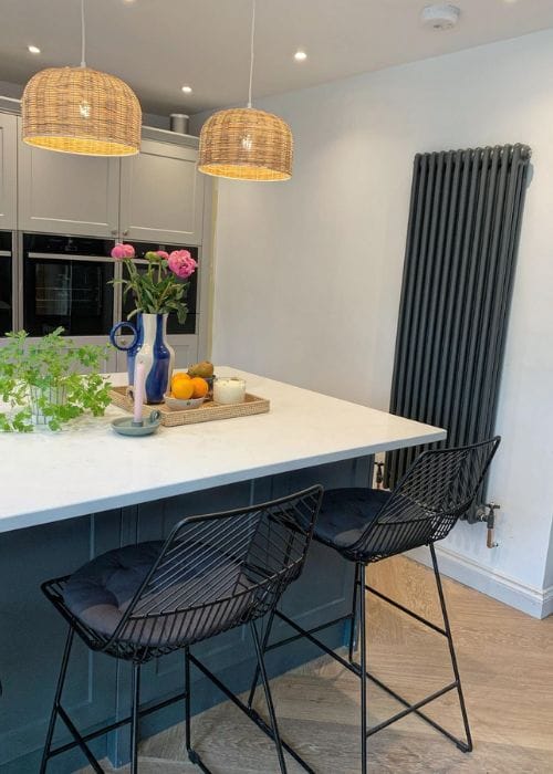 Anthracite grey vertical column radiator in a modern kitchen