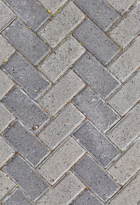 Grey herringbone porcelain paving pattern showing the jointed finish typical of a Joint-It Simple patio