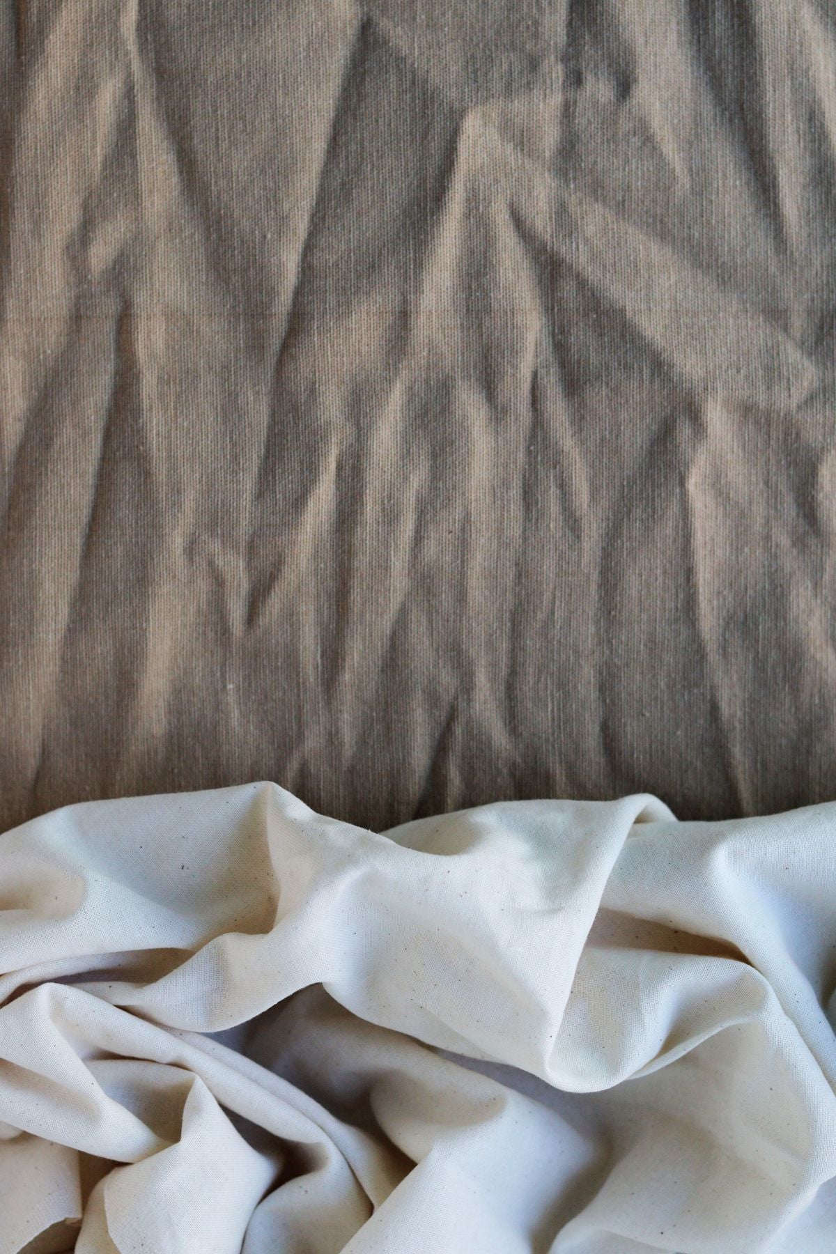 Close-up macro shot comparing the natural woven texture of cotton and linen fibres side by side