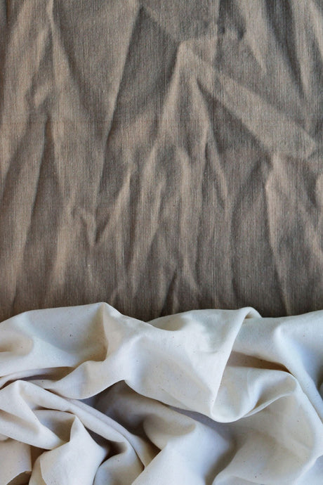 Close-up macro shot comparing the natural woven texture of cotton and linen fibres side by side
