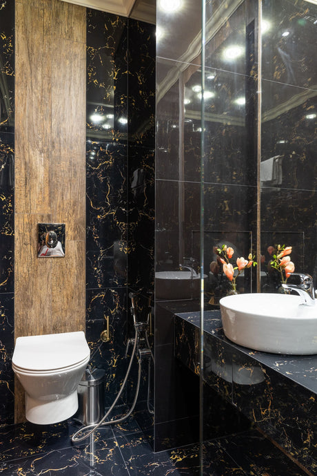 Bathroom with black marble walls and a white basin for contrast