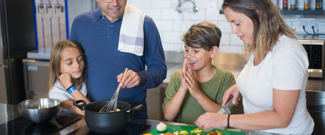 Family in a kitchen preparing food, a safe home environment for using fruit fly traps
