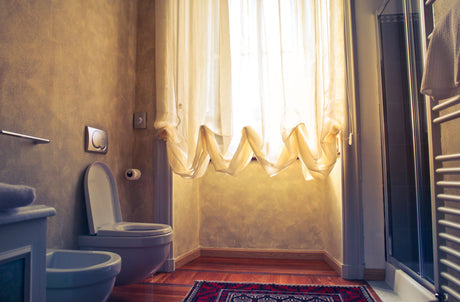 Simple white ceramic toilet, the kind of practical bathroom a plastic seat suits well