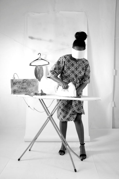 Iron in use on a covered ironing board, illustrating when to replace ironing board cover