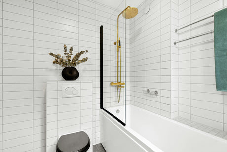 White tiled bathroom with a black toilet