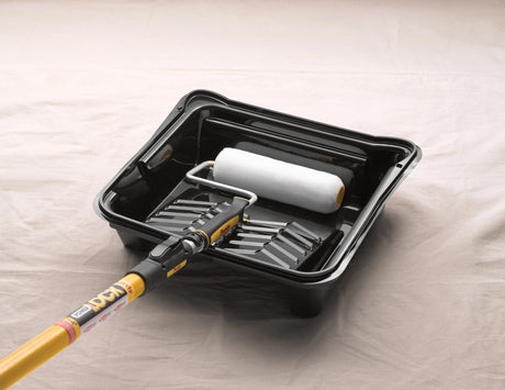 Purdy roller sleeve loaded in a paint tray on a frame with extension pole ready for use