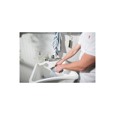 Purdy Premium 10-in-1 Painter's Multi Tool held in hand showing rubberised grip handle