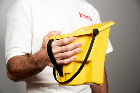 Decorator using the Purdy Pail on site while cutting in paint