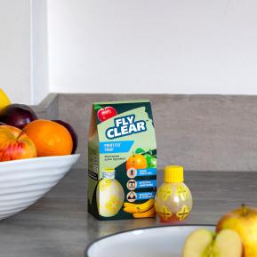 Fly Clear Fruit Fly Trap placed in a kitchen setting as a pesticide-free fruit fly catcher
