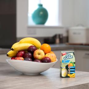 Fly Clear Fruit Fly Trap in use on a kitchen worktop near a fruit bowl to catch fruit flies