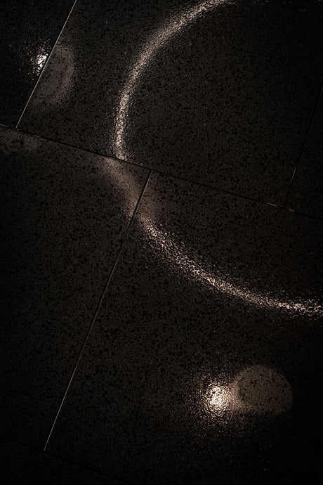 Modern black paving slabs, showing the dark joint finish Joint-It Simple Black creates, wet weather application
