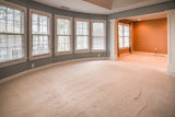 Bright living room with fresh, clean wall-to-wall carpet flooring