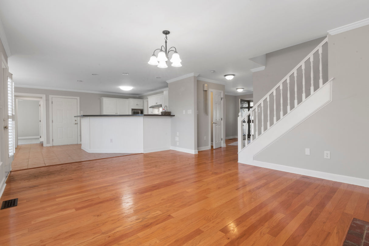 Open-plan living space with warm neutral walls and wood flooring
