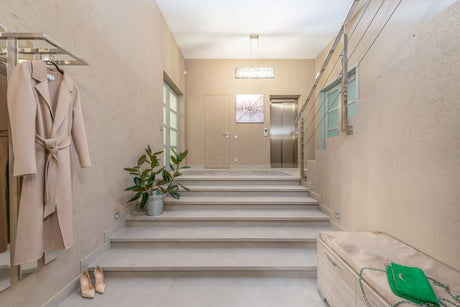 Beige lobby with elevator and staircase, a high-traffic space suited to Dulux Easycare Matt Egyptian Cotton