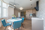 Spacious studio kitchen with beige kitchen furniture close to Dulux Egyptian Cotton