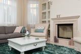 Bright living room with a soft, clean green carpet after stain treatment