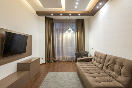Sleek beige living room with sofa and elegant lighting, a warm neutral tone close to Dulux Egyptian Cotton