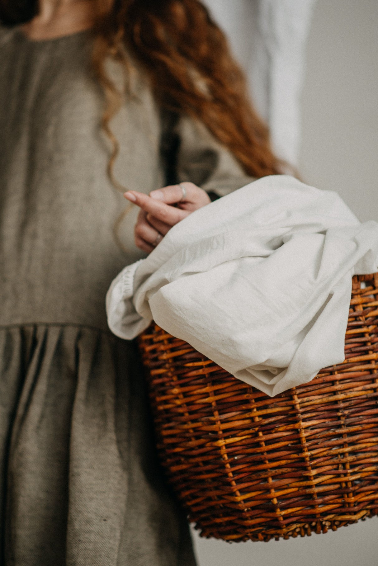 Neatly folded fresh linen in a laundry basket
