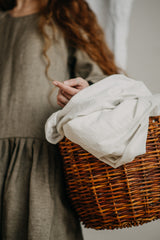 Neatly folded fresh linen in a laundry basket