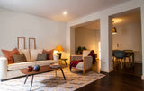 Cozy, bright living room with warm natural light and soft furnishings