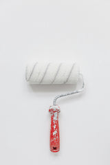 Close up of a white paint roller nap showing the woven fabric pile