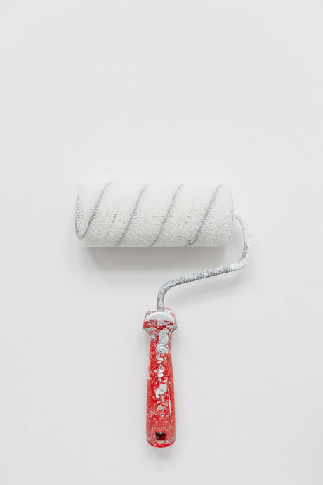 Close up of a white paint roller nap showing the woven fabric pile