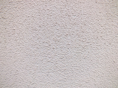 Close up of a textured white render wall surface suited to the Purdy Colossus 9 inch roller sleeve