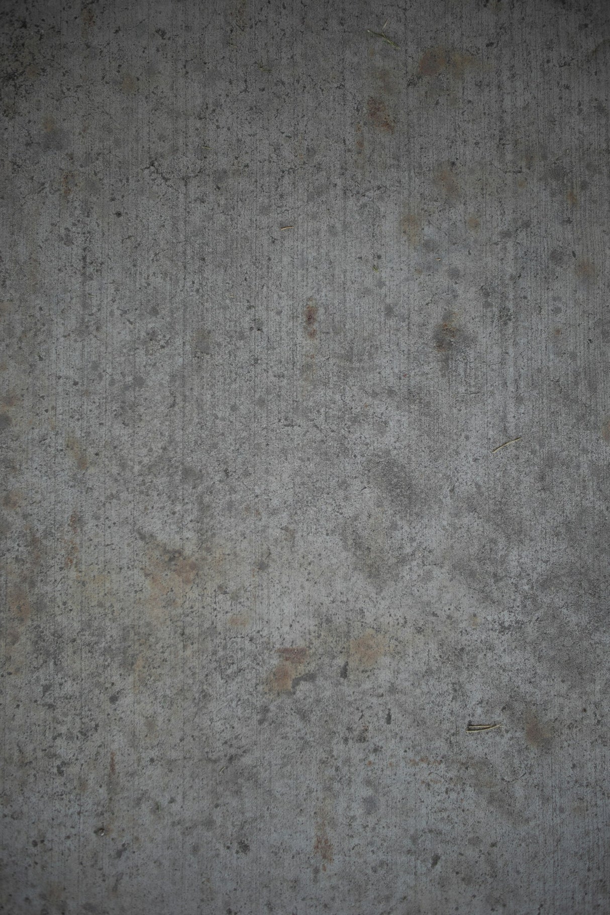 Close up of a textured grey concrete render wall surface suited to a 3/4 inch nap roller sleeve