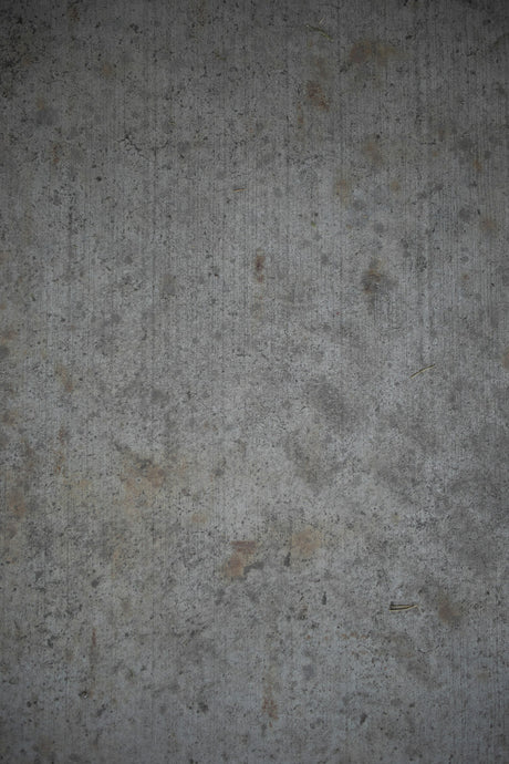Close up of a textured grey concrete render wall surface suited to a 3/4 inch nap roller sleeve