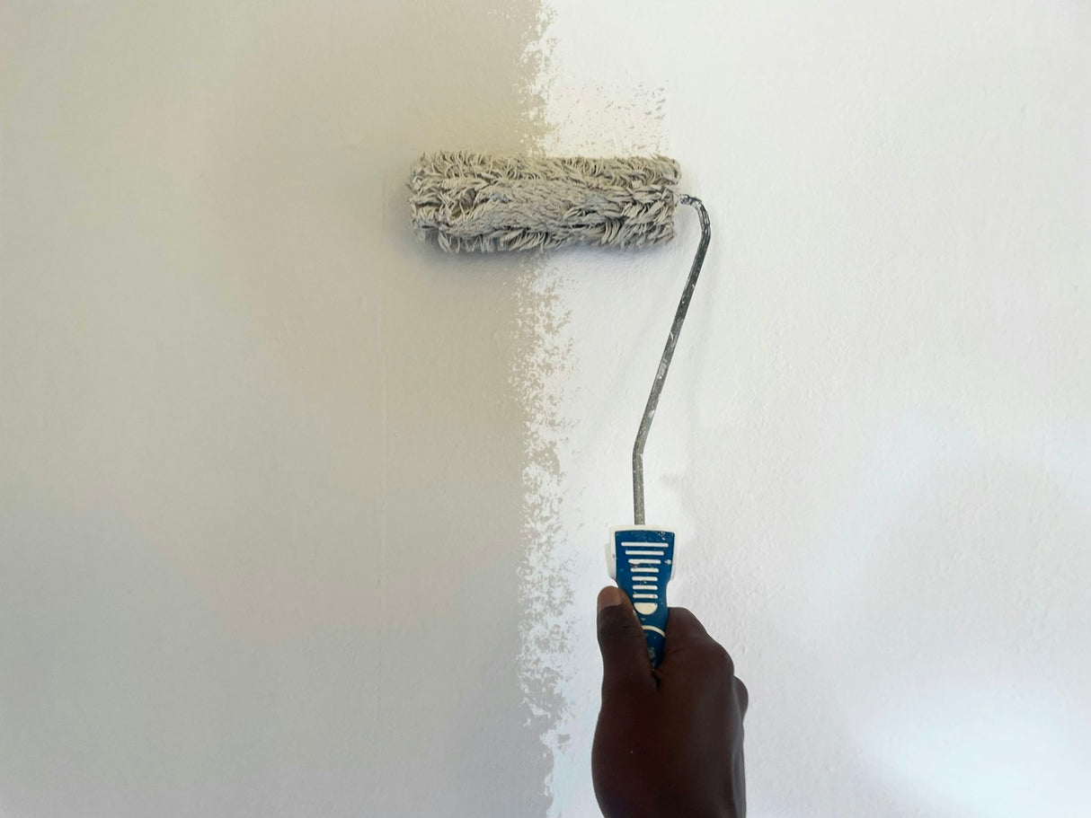 Person rolling paint onto a wall with a wide roller similar to the Purdy Colossus 18 inch sleeve