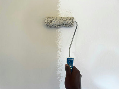 Person rolling paint onto a wall with a wide roller similar to the Purdy Colossus 18 inch sleeve
