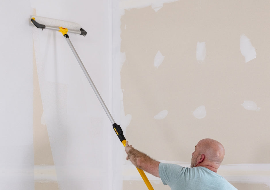 Purdy roller frame being used to roll paint onto an interior wall