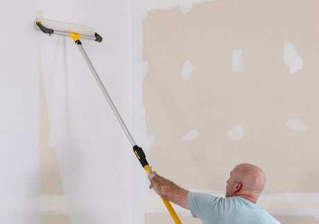 Purdy roller frame being used to roll paint onto an interior wall